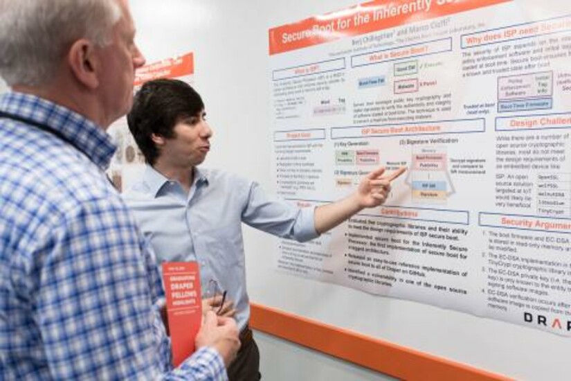 Two people discuss a research poster