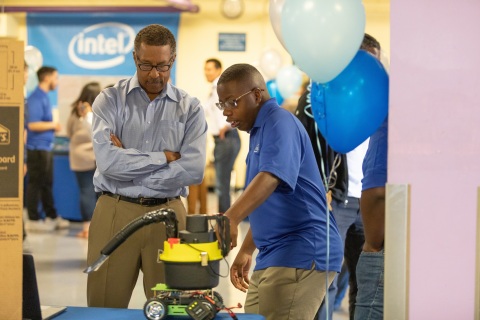 Intel intern Da’Quann Karanja (right) demonstrates his team’s Cleanzi City Wide Cleaning Rover for litter abatement. On completion of their six-week paid internships, 37 interns from Oakland Technical and McClymonds high schools presented projects, many incorporating Intel Corporation technology, to their families, schools and communities during a presentation in Oakland, Calif., on Thursday, July 26, 2018. (Credit: Intel Corporation)