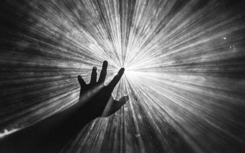 hand reaching towards the light