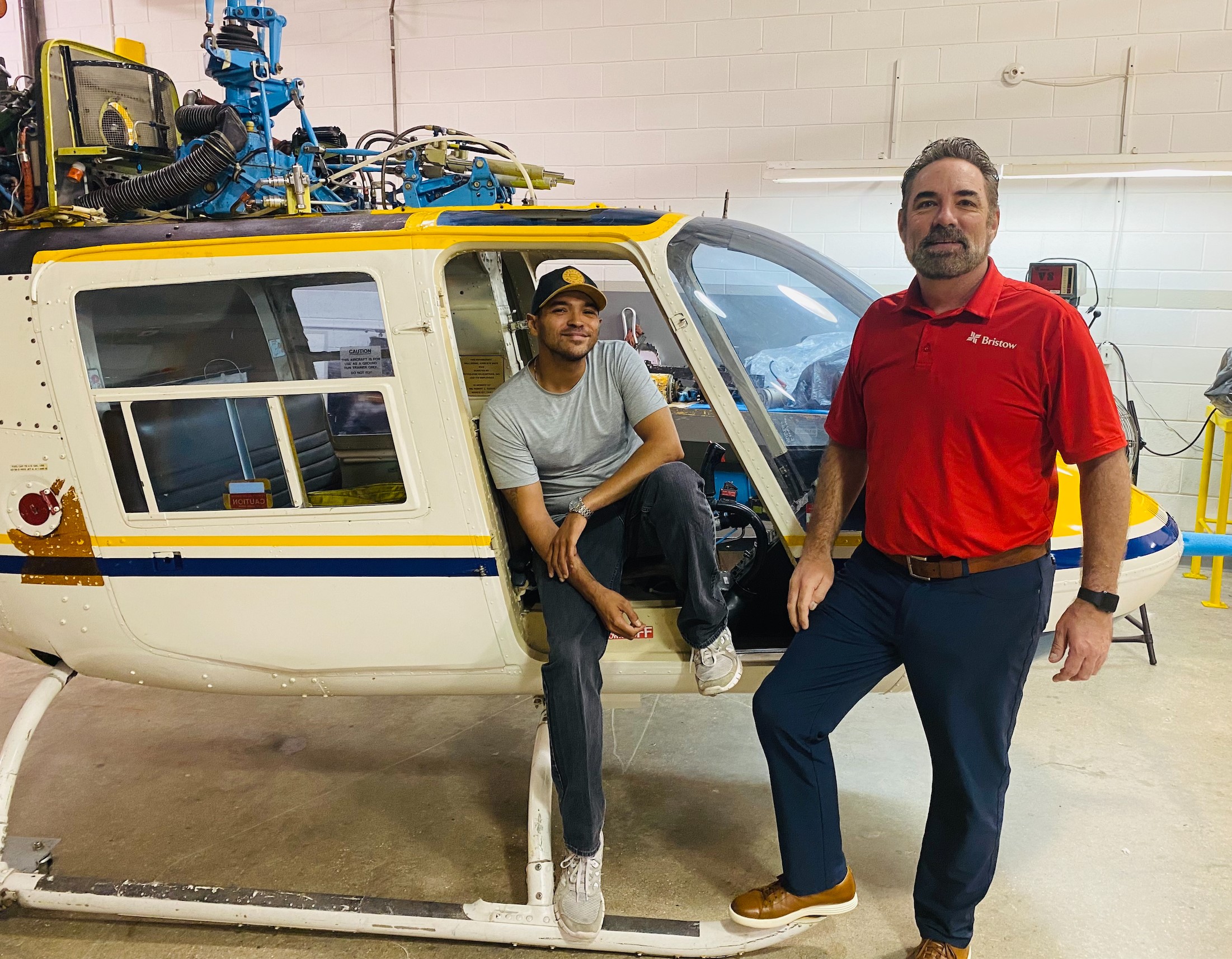 Tyron Sweet, sitting, takes time out from studying to visit with Scott Gibson, HR Manager - Americas. Sweet, a first-generation college student, was awarded the Bristow Scholarship to study Aviation Maintenance Technology at South Louisiana Community College.