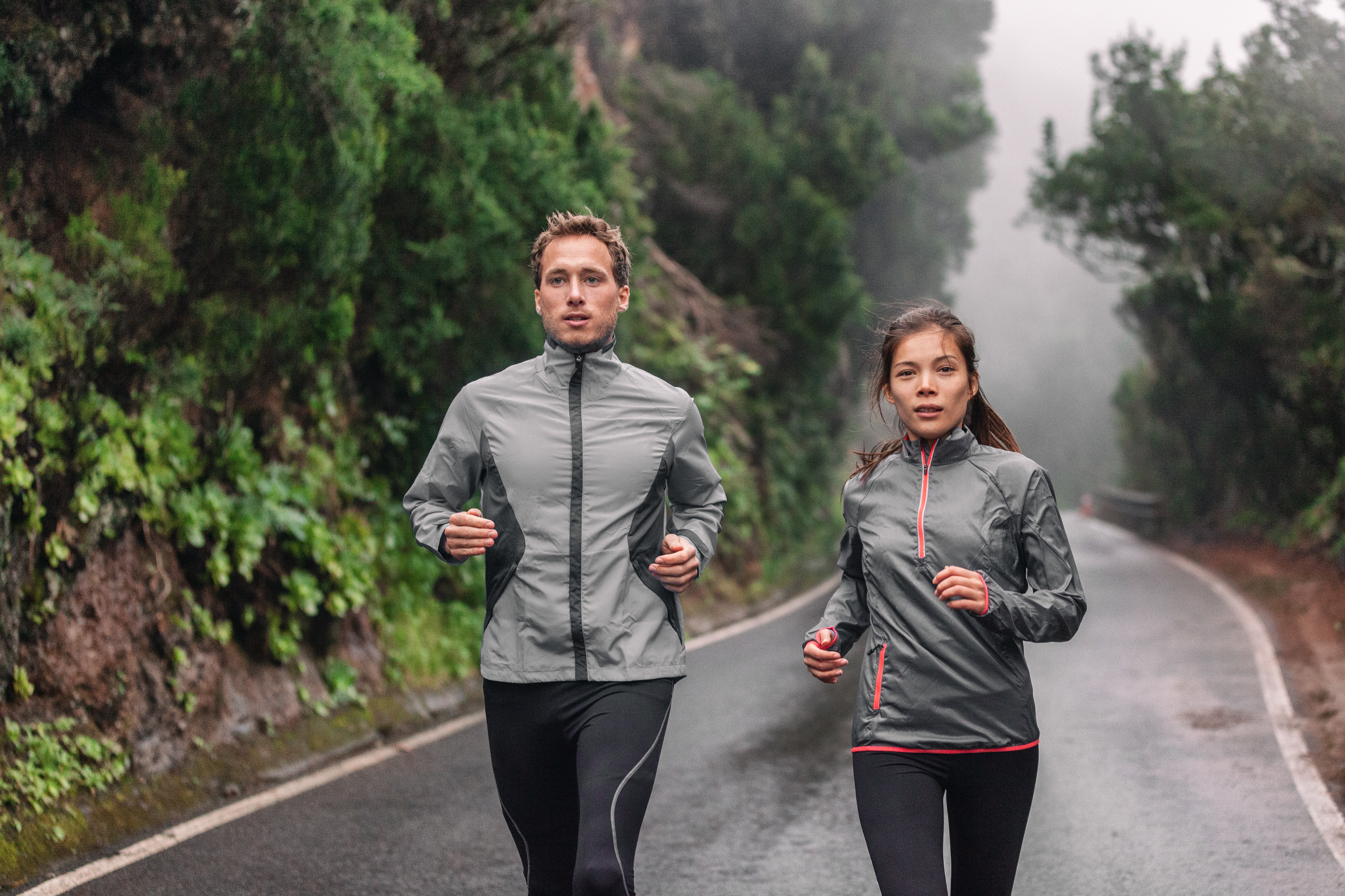 a couple running in a drizzle
